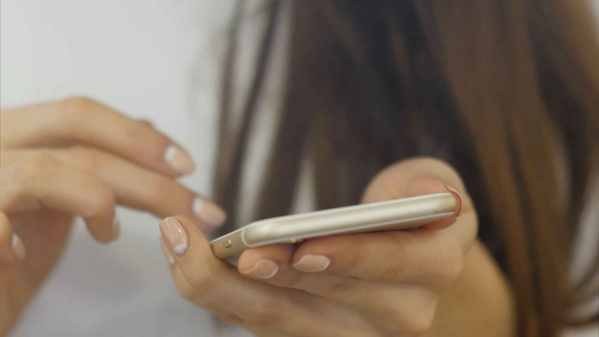 A woman searching for a local business on her phone.